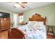 Inviting bedroom with a cozy quilt, ceiling fan, and a view into the hallway, showing a bright, relaxing space at 8506 Old Nichols Hwy., Nichols, SC 29581