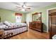 Comfortable bedroom with hardwood floors, decorative mirror, and ample natural light at 8506 Old Nichols Hwy., Nichols, SC 29581