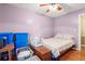 Neutral bedroom with a bed, ceiling fan, and storage containers, offering practical and versatile living space at 8506 Old Nichols Hwy., Nichols, SC 29581
