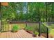 Well-maintained wooden deck with black railings and potted plants, perfect for outdoor enjoyment at 8506 Old Nichols Hwy., Nichols, SC 29581