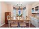 Sunny dining area with a chandelier and bay window, furnished with a wooden table and chairs for cozy meals at 8506 Old Nichols Hwy., Nichols, SC 29581