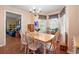 Bright dining room with wood table, chandelier, and large windows at 8506 Old Nichols Hwy., Nichols, SC 29581