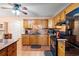 Cozy kitchen with warm wood cabinets, granite countertops, and black appliances at 8506 Old Nichols Hwy., Nichols, SC 29581