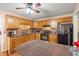 Cozy kitchen with granite countertops, warm wood cabinets, and black appliances at 8506 Old Nichols Hwy., Nichols, SC 29581
