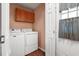 Practical laundry room featuring a washer, dryer, and cabinet, designed for efficient household chores at 8506 Old Nichols Hwy., Nichols, SC 29581