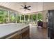 Inviting screened porch with hot tub, outdoor seating, and ceiling fan, offering a tranquil retreat at 8506 Old Nichols Hwy., Nichols, SC 29581