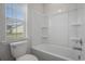 Bathroom with a toilet and a bathtub and a window at 8761 Nw Nashville Dr., Calabash, NC 28467