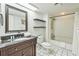 Clean bathroom with a dark wood vanity, bathtub with shower, and a bright vanity mirror at 9550 Shore Dr. # 1418, Myrtle Beach, SC 29572