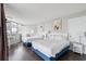 Bright bedroom features two beds, wood floors, art, and plenty of natural light from the windows at 9550 Shore Dr. # 1418, Myrtle Beach, SC 29572