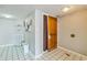 Hallway featuring artwork, a wooden entry door, and tiled flooring near a shelving unit at 9550 Shore Dr. # 1418, Myrtle Beach, SC 29572