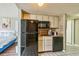Compact kitchen with a black refrigerator, microwave, and dishwasher in a cozy space at 9550 Shore Dr. # 1418, Myrtle Beach, SC 29572