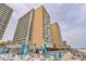 View of the expansive pool deck, lounge seating and hotel exterior at 9550 Shore Dr. # 1418, Myrtle Beach, SC 29572