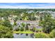 Aerial view showcasing beautiful wooded neighborhood and a lake at 97 Shadow Moss Pl. # 97, North Myrtle Beach, SC 29582