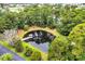 Aerial view of the pond and gazebo surrounded by lush trees at 97 Shadow Moss Pl. # 97, North Myrtle Beach, SC 29582