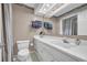 Clean bathroom featuring a white vanity, mirror, and toilet at 97 Shadow Moss Pl. # 97, North Myrtle Beach, SC 29582