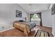 Cozy bedroom with wood floors, ceiling fan, and a bright window at 97 Shadow Moss Pl. # 97, North Myrtle Beach, SC 29582
