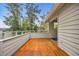 A wooden porch, with a railing, offering views of the neighborhood at 97 Shadow Moss Pl. # 97, North Myrtle Beach, SC 29582