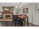 Cozy dining room featuring a stone fireplace, chandelier, and wood flooring at 97 Shadow Moss Pl. # 97, North Myrtle Beach, SC 29582