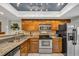 Well-equipped kitchen featuring stainless steel appliances, granite countertops, and wood cabinetry at 97 Shadow Moss Pl. # 97, North Myrtle Beach, SC 29582