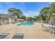 Community pool with lounge chairs for relaxing in the sun surrounded by trees at 97 Shadow Moss Pl. # 97, North Myrtle Beach, SC 29582