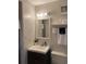Well-lit bathroom with a modern vanity, mirror, and decorative accents at 10200 Lake Shore Dr. # 4, Myrtle Beach, SC 29572
