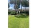 Exterior of condo with a lush lawn, mature palms, and a view of the community pool at 10200 Lake Shore Dr. # 4, Myrtle Beach, SC 29572