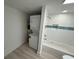 Bathroom with subway tiled shower/bath and washer/dryer combo unit at 1022 Holt Rd., Conway, SC 29526