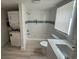 Well-lit bathroom with white tiles, modern fixtures, and washer/dryer combo at 1022 Holt Rd., Conway, SC 29526