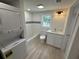 Bathroom featuring new fixtures, washer dryer, bathtub and subway tile with accent at 1022 Holt Rd., Conway, SC 29526