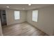 Bright, light bedroom featuring wood-look flooring and two windows at 1022 Holt Rd., Conway, SC 29526