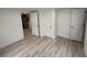 Cozy bedroom featuring neutral walls, three white doors, and light hardwood flooring at 1022 Holt Rd., Conway, SC 29526