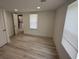 Bedroom with window, light wood floors, white walls, and bathroom with washer dryer view at 1022 Holt Rd., Conway, SC 29526