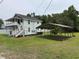 Rear exterior view of a home with a carport and grassy yard at 1022 Holt Rd., Conway, SC 29526