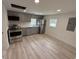 Modern kitchen featuring stainless steel appliances, gray cabinets, and light hardwood floors at 1022 Holt Rd., Conway, SC 29526