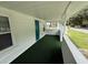 Outdoor porch with green carpet and a side door at 1022 Holt Rd., Conway, SC 29526