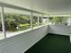 Enclosed porch with green turf flooring and neighborhood views at 1022 Holt Rd., Conway, SC 29526