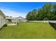 Large backyard with green grass, fenced perimeter, playground and patio with pergola at 104 Browns Hollow Ct., Loris, SC 29569