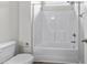 Full bathroom showcasing a toilet and tub/shower combo with white tile surround at 104 Browns Hollow Ct., Loris, SC 29569