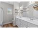 Bathroom featuring a double vanity, modern fixtures, floating shelves, and a shower/tub combo at 104 Browns Hollow Ct., Loris, SC 29569