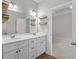 Bathroom featuring a double vanity, modern fixtures, floating shelves, and access to a bedroom at 104 Browns Hollow Ct., Loris, SC 29569