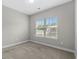 Bedroom with neutral carpet, large window offering plenty of natural light, and gray paint at 104 Browns Hollow Ct., Loris, SC 29569