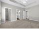 Bedroom with en-suite bathroom access, neutral carpet, ceiling fan, and trey ceiling at 104 Browns Hollow Ct., Loris, SC 29569