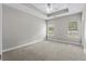 Spacious bedroom featuring neutral carpet, two windows, ceiling fan, and trey ceiling at 104 Browns Hollow Ct., Loris, SC 29569