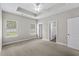 Bedroom with neutral carpet, two windows, ceiling fan, and trey ceiling at 104 Browns Hollow Ct., Loris, SC 29569