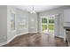 Bright dining area with a sliding glass door, neutral walls and floors, and an elegant modern chandelier at 104 Browns Hollow Ct., Loris, SC 29569