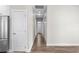 Hallway with modern flooring, neutral walls, white trim, and multiple doors, offering a clean aesthetic at 104 Browns Hollow Ct., Loris, SC 29569