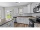 Modern kitchen with white cabinetry, stainless steel appliances, granite countertops, and a view to the backyard at 104 Browns Hollow Ct., Loris, SC 29569