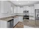 Well-lit kitchen with white cabinets, granite countertops, stainless steel appliances, and a stylish subway tile backsplash at 104 Browns Hollow Ct., Loris, SC 29569