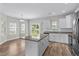 Modern kitchen features white cabinets, stainless steel appliances, and a granite island at 104 Browns Hollow Ct., Loris, SC 29569