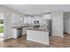 Modern kitchen features white cabinets, stainless steel appliances, and a granite island at 104 Browns Hollow Ct., Loris, SC 29569